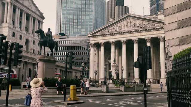 Lady taking a photo of The Royal Exchange in City of London, 2018