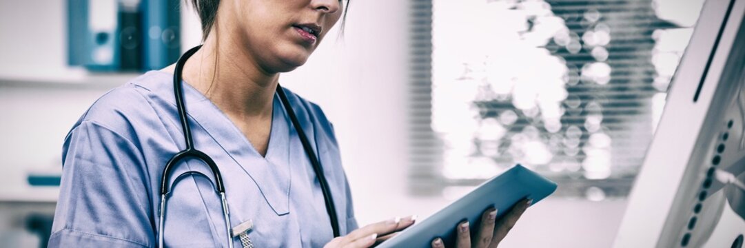 Female surgeon using digital tablet