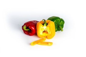 Yellow green and red bell sweet pepper with white background.