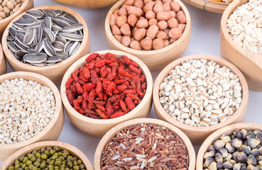 Cereal grains , seeds, beans on wooden background