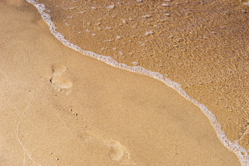 Close up water on the beach with brown sand in sunshine day for backdrop background