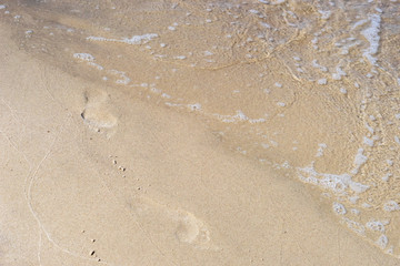 Close up water on the beach with brown sand in sunshine day for backdrop background