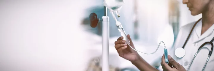 Fotobehang Nurse connecting an intravenous drip © vectorfusionart