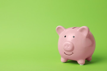 Pink piggy bank on color background. Money saving