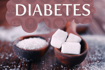 White sand and lump sugar in spoons on wooden background