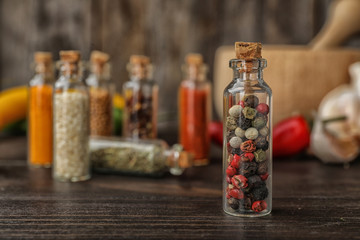 Bottles with different spices on table