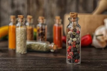 Fotobehang Bottles with different spices on table © New Africa