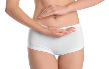 Young woman holding hands near underwear on white background. Gynecology