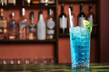 Glass with delicious cocktail on table in cafe