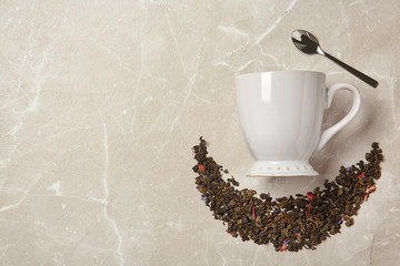 Flat lay composition with dry tea and cup on grey background