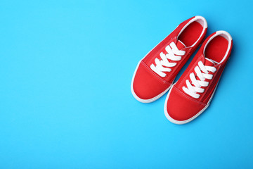 Stylish new shoes on color background, top view