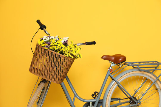 Fototapeta Retro bicycle with wicker basket on color background