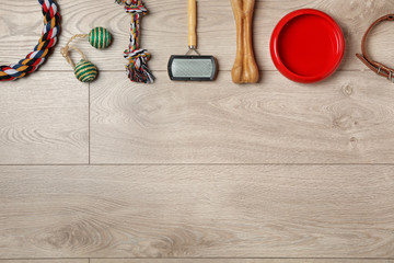 Flat lay composition with accessories for dog and cat on wooden background. Pet care