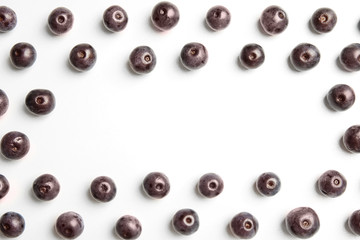 Fresh acai berries on white background