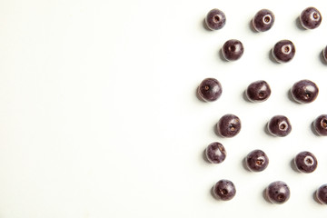 Fresh acai berries on white background