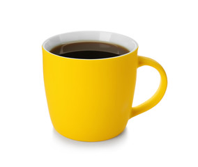 Yellow ceramic cup with hot aromatic coffee on white background