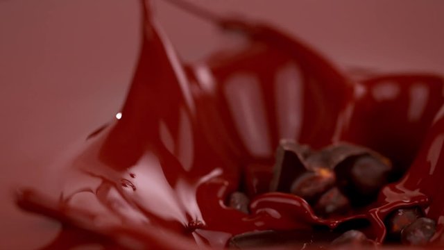 Super slow motion of falling piece of chocolate bar falling into hot chocolate. Filmed with cinema high speed camera, 1000fps.