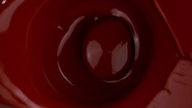 Super slow motion of falling piece of chocolate bar falling into hot chocolate. Filmed with cinema high speed camera, 1000fps.
