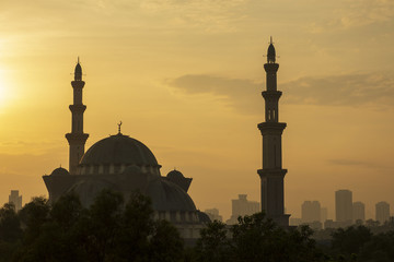 Fototapeta na wymiar Federal Territory Mosque in silhouette during sunrise