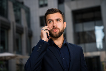 Confident young entrepreneur talking by phone.