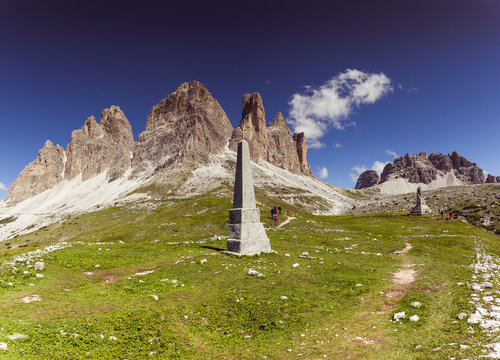 Tourists near monument to the fallen of the First World War at the foot of the Tre Cime di Lavaredo