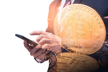 The double exposure image of the businessman using a smartphone overlay with bitcoins image. the concept of cryptocurrency, blockchain, internet of things and future life