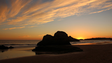 Naklejka na ściany i meble Sunset in empty beach and clouds in the sky