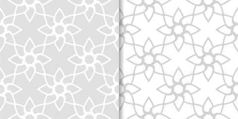 Light gray floral backgrounds. Set of seamless patterns