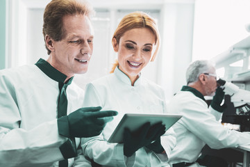 Blonde-haired biologist. Blonde-haired professional biologist smiling while cooperating with her...