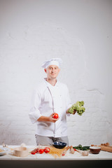 Chef. Paste. Ingredients. Recipes of Italian cuisine. Food concept. Preparing traditional italian dish. Food concept. Preparing traditional italian dish. Smiling chef in white uniform and white hat.