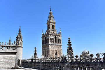 Fototapeta na wymiar A view of the Giralda bell tower and the Cathedral of Saint Mary of the See in Seville, Andalucia, Spain
