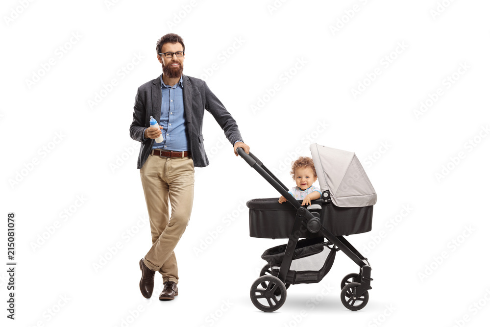 Wall mural father with a bottle of milk and a baby boy in a stroller