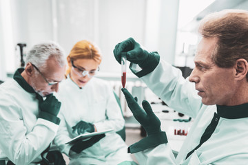 Obraz premium Sensational discovery. Famous experienced chemist working hard while completing extremely sensational discovery