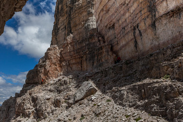 Fototapeta premium Hikers along the mountaineering path that passes through the posts of the First World War, Mount Paterno, Dolomites, Italy