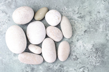 Round light sea stones on gray blue background