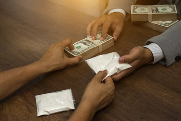 drug trafficking, crime, addiction and sale concept - close up of addict hands with drugs and money