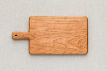 Cherry wood cutting board on linen, handmade wood cutting board	
