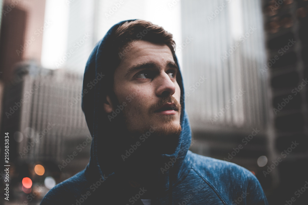 Wall mural close up of a man with some beard looking away 