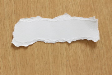 torn paper texture on wood background, copy space.