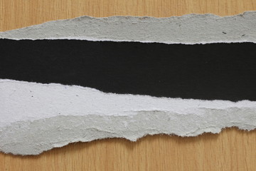 torn paper texture on wood background, copy space.