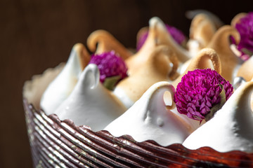 Cake with whipped eggs whites on black background