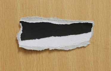 torn paper texture on wood background, copy space.