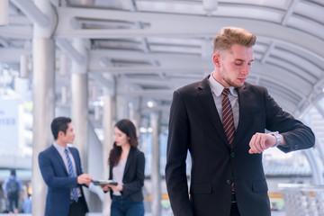 Fototapeta premium Business man seeing wristwatch to check time at office.annual and summary report.It's Time out for appointment meeting.Time out concept