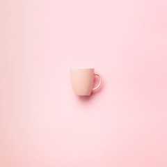 Pink cup over punchy background. Square crop. Birthday party celebration, baby shower concept. Pastel colors pattern. Banner. Minimalist style design