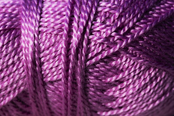 Abstract closeup of yarn, ball of purple textile material