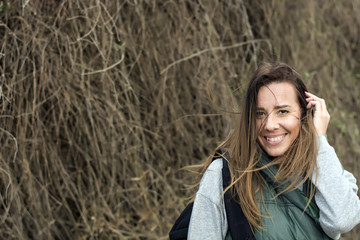 Smiling young woman tourist walking in nature