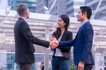 Business people group Business people group happy showing teamwork and joining hands or giving five after signing agreement or contract in office.