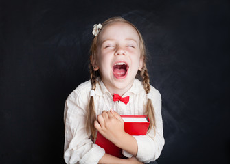 Child with book having fun and laughing. Smart child. Love school and education concept