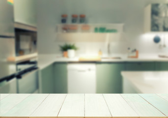 Wood table top on blurred kitchen background
