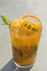 mango mojito in sunny day over a grey metallic table